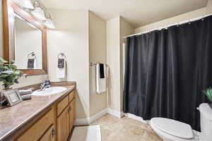 Bathroom with vanity, a shower with curtain, and light tile patterned flooring