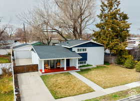 View of front of home with a porch, driveway, and a residential view