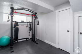 Workout area featuring dark rubber floors and baseboards