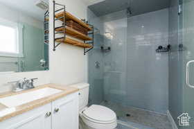 Bathroom with vanity and a shower stall