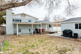 Rear view of property with a patio area and a chimney