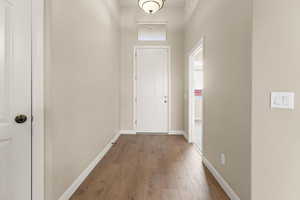 Doorway to outside featuring baseboards and hardwood / wood-style flooring