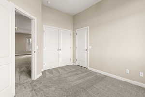 Unfurnished bedroom featuring carpet floors and a closet