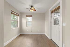 Unfurnished room with light wood-style flooring and ceiling fan