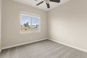 Empty room with carpet flooring and a ceiling fan