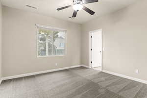 Spare room with carpet and ceiling fan