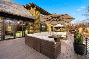 Wooden deck featuring an outdoor living space with a fire pit