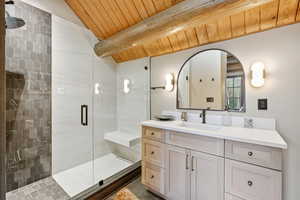 Full bath with wood ceiling, vanity, and a stall shower