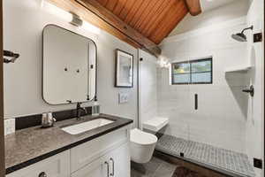 Bathroom with vanity, a stall shower, and wooden ceiling