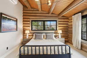 Bedroom featuring wooden ceiling, rustic walls, light colored carpet, multiple windows, and a wall mounted AC
