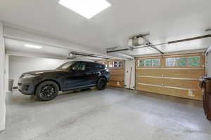 Garage featuring a garage door opener