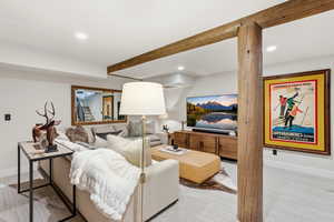 Living area featuring light colored carpet and recessed lighting