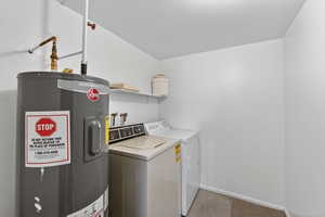 Laundry area featuring water heater and washing machine and dryer