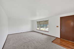 Unfurnished room featuring carpet floors and a textured ceiling
