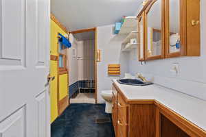 Full bath with curtained shower, vanity, and dark carpet