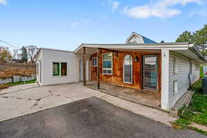 View of front facade featuring a patio and driveway