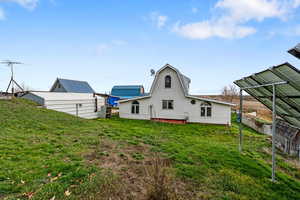 Back of property with a gambrel roof