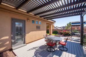 Deck with outdoor dining space, a fenced backyard, and a pergola
