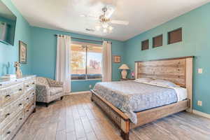 Bedroom featuring light wood-style flooring and a ceiling fan