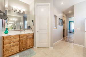 Full bathroom featuring vanity and light tile patterned flooring