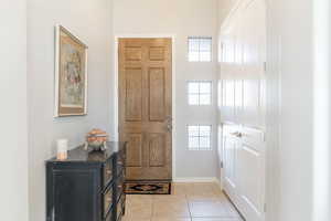 Entryway with light tile patterned flooring and plenty of natural light