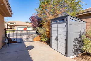 View of patio / terrace with a gate and an outdoor structure