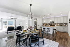 Dining room featuring dark wood-style floors, a ceiling fan, and recessed lighting