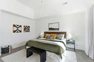 Carpeted bedroom featuring baseboards