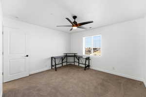Unfurnished room featuring carpet flooring and a ceiling fan