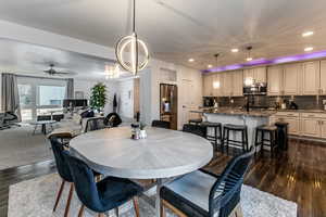 Dining space with dark wood finished floors, recessed lighting, and ceiling fan