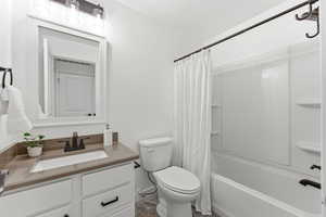 Bathroom with vanity and shower / bath combo with shower curtain