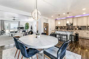 Dining area with dark wood finished floors, recessed lighting, and ceiling fan