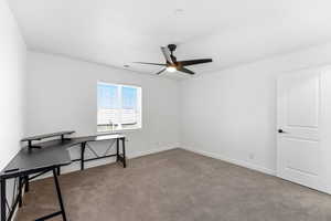 Unfurnished office featuring light carpet and a ceiling fan