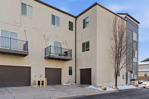 View of building exterior with an attached garage and driveway