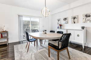 Dining space with baseboards and dark wood-style floors