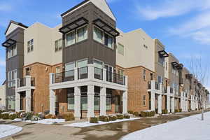 Snow covered property featuring a view of apartment building / complex