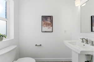 Bathroom featuring toilet and baseboards