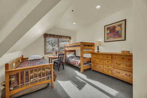 Carpeted bedroom featuring lofted ceiling and recessed lighting