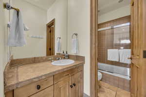 Full bathroom featuring tiled shower / bath and vanity