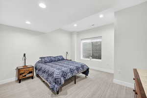 Bedroom featuring light colored carpet and recessed lighting