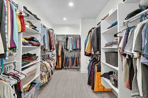 Walk in closet featuring light colored carpet