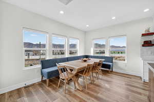 Dining area with recessed lighting, light wood-style flooring, and a mountain view