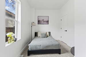 Carpeted bedroom with baseboards