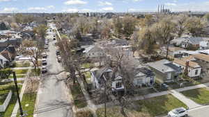 Aerial view of property and surrounding area featuring nearby suburban area