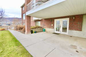 Patio / terrace featuring a patio area, a lawn, and french doors