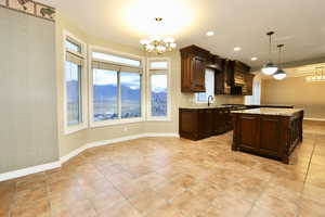 Kitchen / informal dining with a chandelier, a mountain view, decorative light fixtures, and recessed lighting.