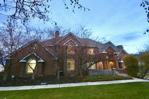 View of front of house featuring a large, well manicured, private yard