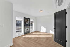 Unfurnished room featuring light wood-style flooring and baseboards