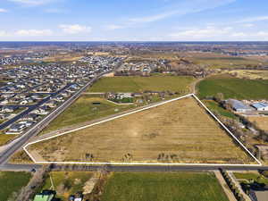 Aerial overview of property's location with property boundaries highlighted, rural landscape, and rows of crops