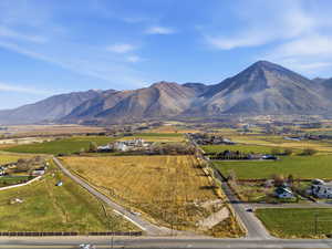 View of mountain backdrop featuring rural landscape and farmland